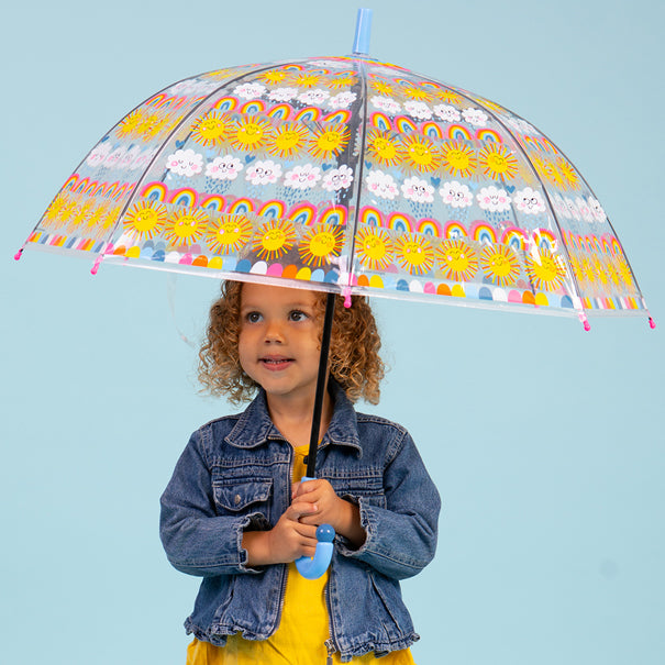 Child using sun rainbows and clouds umbrella outdoors showing full dome coverage with rainbow pattern