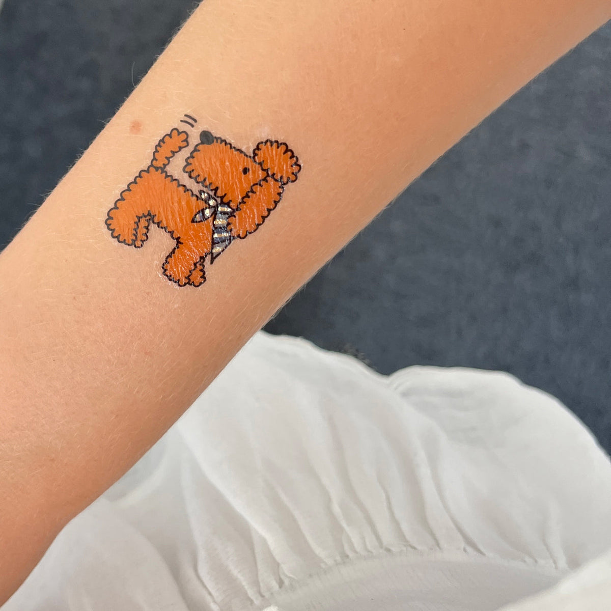 Temporary tattoo of a small dog on a person&