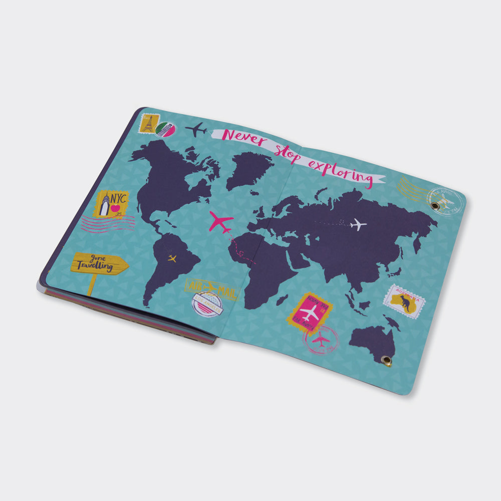 Travel planner and journal open showing illustrated world map spread