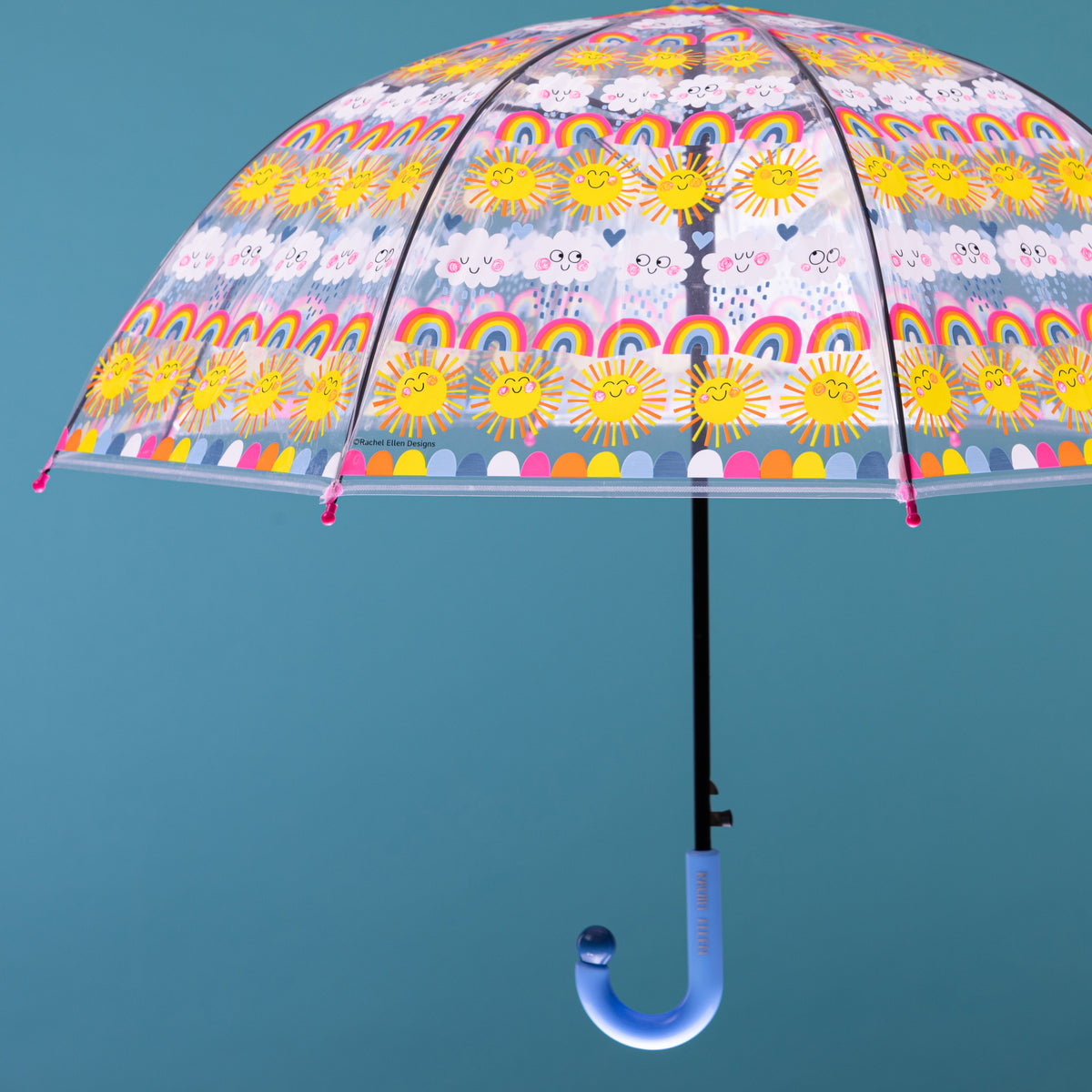 Sun rainbows and clouds umbrella displayed open showing full rainbow, sun and cloud pattern across dome