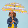 Child using sun rainbows and clouds umbrella outdoors showing full dome coverage with rainbow pattern