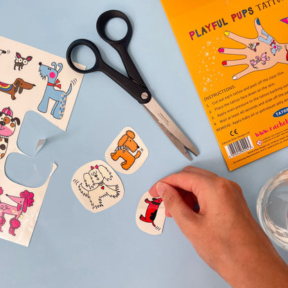 Playful pups tattoo set with scissors and packaging on a blue background