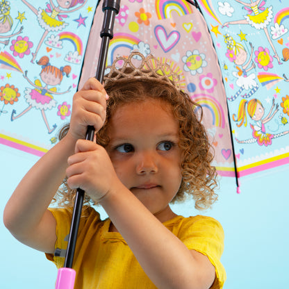 Girl holding fairy ballerina umbrella displaying clear dome with pink ballerinas and rainbow design