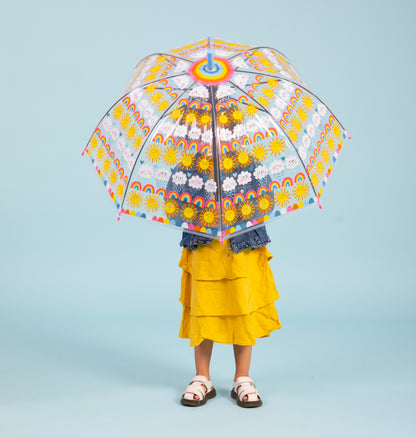 Child holding sun rainbows and clouds umbrella showing see-through dome with colorful rainbow and sun graphics"