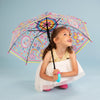 Girl holding girl power umbrella outdoors displaying clear dome with rainbow and cloud design