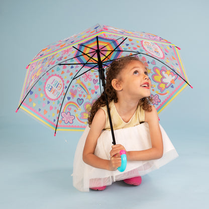 Girl holding girl power umbrella outdoors displaying clear dome with rainbow and cloud design