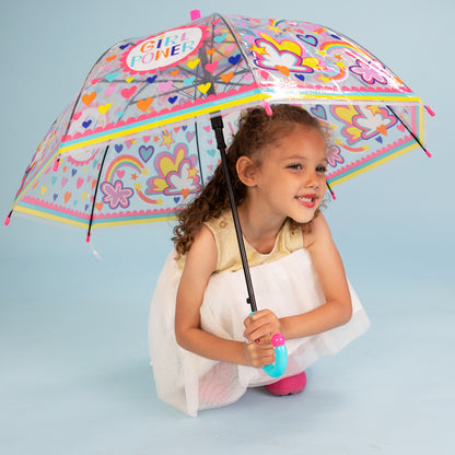Girl holding girl power umbrella outdoors displaying clear dome with rainbow and cloud design