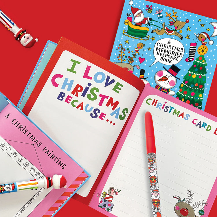 Close up of the open Christmas Keepsake Journal showing colourful, illustrated pages and a writing prompt section for recording 10 years of family memories.