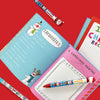 Close up of the open Christmas Keepsake Journal showing colourful, illustrated pages and a writing prompt section for recording 10 years of family memories.